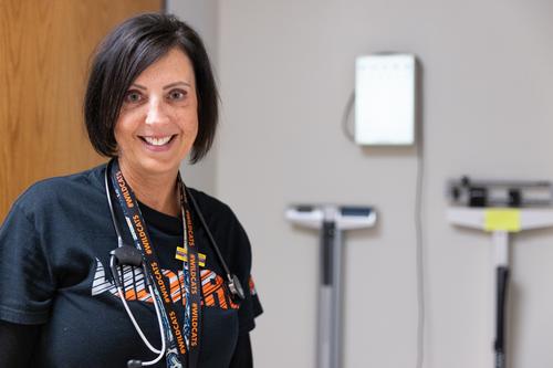 A nurse poses in her office